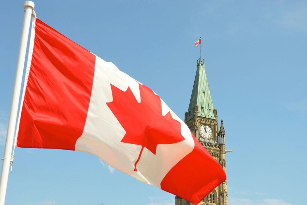 Canadian flag waves before parliment